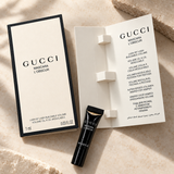 Gucci Mascara L'Obscur tube with open booklet on marble surface
